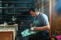 That's Yilmaz! He's hand stitching the leather upper to the sole of the shoe at the Sabah Workshop in Gaziantep, Turkey.